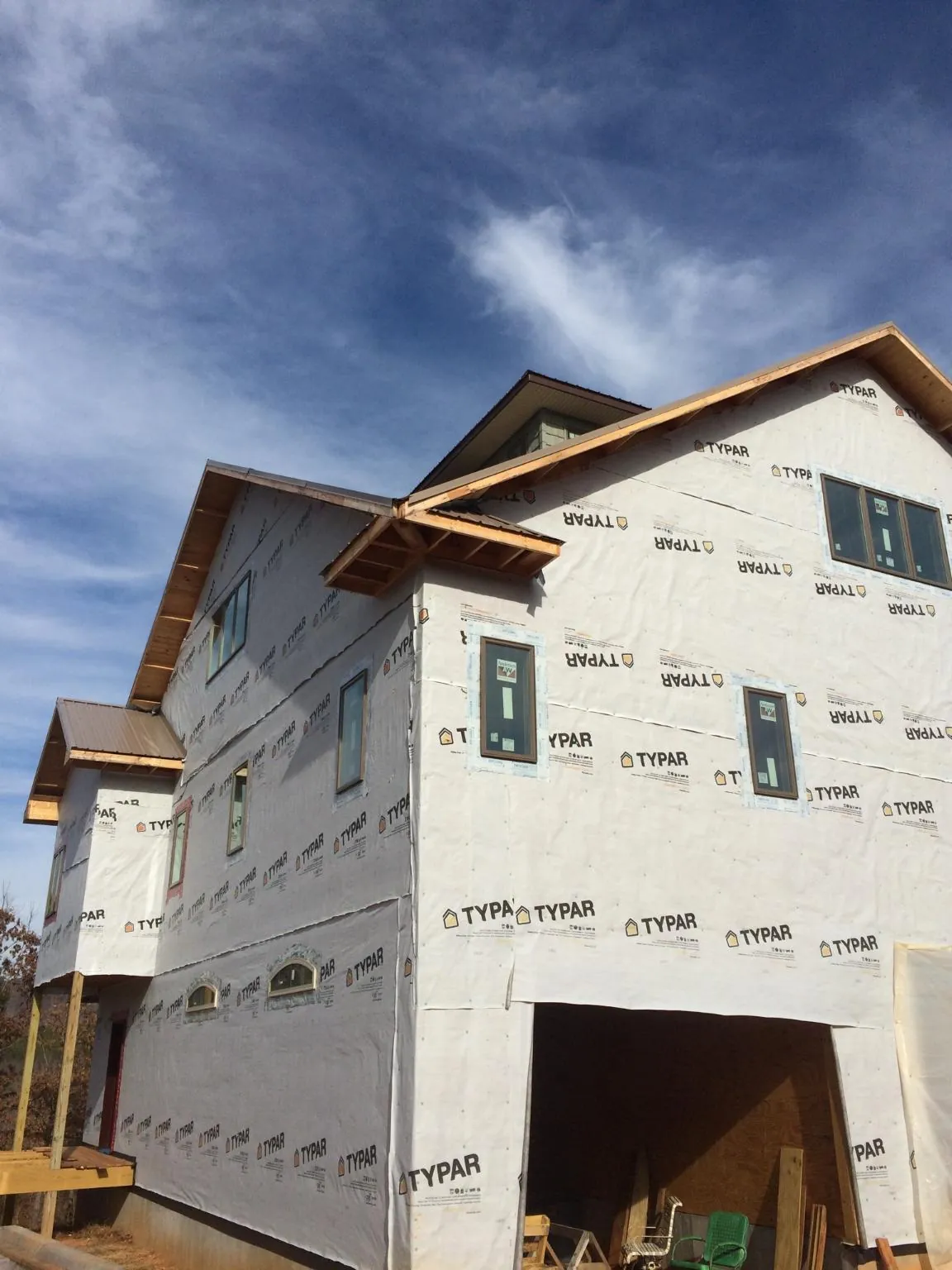 Stick built house wrapped in Typar with new roof framing and dormers in Hematite